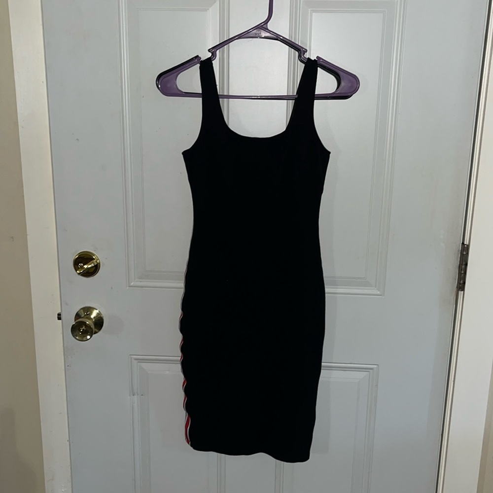 Black bodycon dress with red and white stripes down the sides.